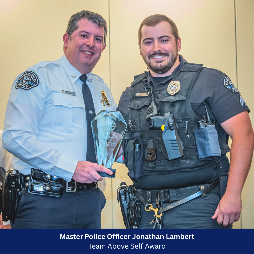 Officer Lambert receiving award from Deputy Chief Hill
